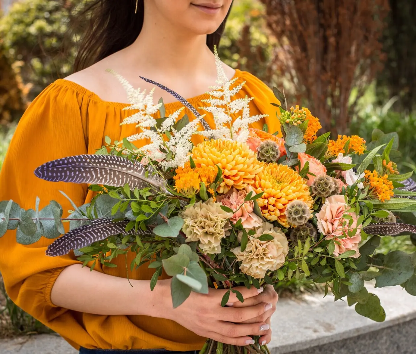Beautiful summer flowers in a girl's hands.
