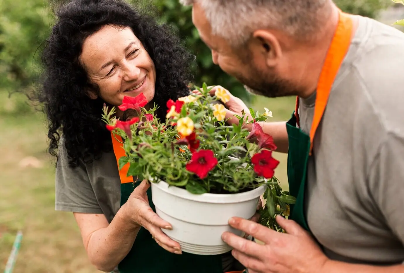 Happy elderly couple with flowers